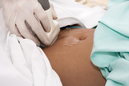 Scanning of a stomach of pregnant woman